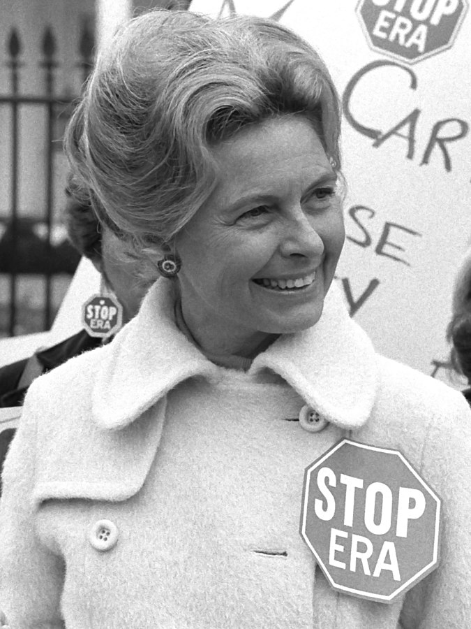 Activist_Phyllis_Schafly_wearing_a__Stop_ERA__badge_demonstrating_with_other_women_against_the_Equal_Rights_Amendment_in_front_of_the_White_House_Washington_D.C._42219314092_cropped_2